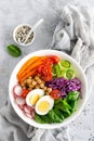 Buddha bowl salad with chickpeas, sweet pepper, tomato, cucumber, red cabbage kale, fresh radish, spinach leaves and boiled egg Royalty Free Stock Photo