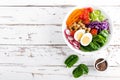 Buddha bowl salad with chickpeas, sweet pepper, tomato, cucumber, red cabbage kale, fresh radish, spinach leaves and boiled egg Royalty Free Stock Photo