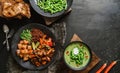 Buddha bowl salad with salmon, red quinoa, baked vegetables, micro greens, peas cream soup with green beans in bowl on dark wooden Royalty Free Stock Photo