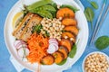 Buddha bowl with vegetables, tofu, baked sweet potato, sprouts c Royalty Free Stock Photo