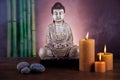 Buddha with candle, vivid colors, natural tone Royalty Free Stock Photo