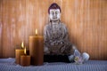 Buddha with candle, vivid colors, natural tone Royalty Free Stock Photo