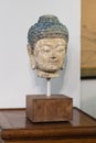 Buddha Ceramic Face Statue on Little Wooden Table