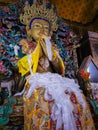 Buddha disciple golden statue close up shot at monastery from different perspective