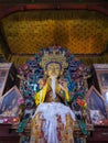 Buddha disciple golden statue close up shot at monastery from different perspective