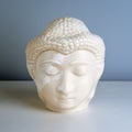 Buddha face. Buddha statue made of white marble. Concept of peace, calm and tranquility. Buddhist artifact for Zen style