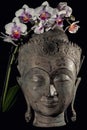 Buddha face and orchid flower. Spiritual meditation and Zen buddhism nature image Royalty Free Stock Photo