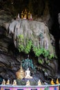 Buddha figures inside a temple built on a sacred cave. Figures above and below the stalactites. Karst landscape at Hpa An, Myanmar