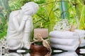 Buddha figurine with a stack of towels and a candle - spa arrangement