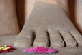 Buddha foot with floreal offerings Royalty Free Stock Photo