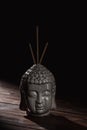 Buddha head with incense sticks Royalty Free Stock Photo