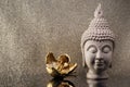 Buddha head statue and golden orchid flower. Royalty Free Stock Photo