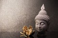 Buddha head statue and golden orchid flower on a gold background and copy space for text. Royalty Free Stock Photo