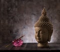 Buddha head statue, incense and lotus flower decoration. Royalty Free Stock Photo