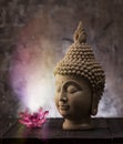 Buddha head statue and lotus flower decoration. Royalty Free Stock Photo