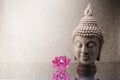 Buddha head statue and Orchid flower decoration and copy space for text. Royalty Free Stock Photo