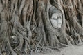 Buddha head in tree roots. Wat Mahathat Ayutthaya. Thailand Royalty Free Stock Photo