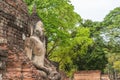 Buddha image in front of ruined pagoda.