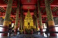 Buddha image in golden pagoda at the main hall of Wat Prathat Lampang Luang, an ancient Buddhist temple in Lampang, Thailand.
