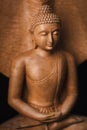 Wooden Buddha in a meditation pose. Royalty Free Stock Photo