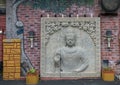 Buddha relief outside wall of the Cosmic Cafe on Oak Lawn in Dallas, Texas.