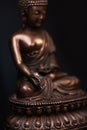 Buddha`s figure, brown color made of metal in a meditation pose Royalty Free Stock Photo