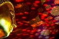 Buddha's golden face, The background is the reflection of the stained glass on the red ceiling