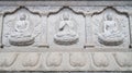 Buddha\'s three seated poses on stone wall reliefs at Huguo Miaochong Temple in Qingliang Mountain