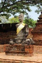 Buddha sculpture in the stone and brick ruins of the historic temple of Wat Phra Sri Sanphet. Ayutthaya, Thailand.