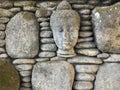 Buddha sculture on round stone wall