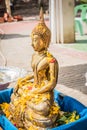 the Buddha stands Prepared for people are pour water of Songkran festival day