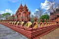 Buddha statue arranged on low wall surrounding temple church of Khao phra angkhan temple on extinct volcanoes at Buriram province