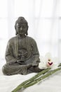 Buddha statue with bamboo and orchid flower Royalty Free Stock Photo