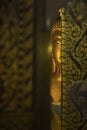 Buddha statue behind temple door Royalty Free Stock Photo