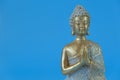 Buddha statue on a blue background.Meditation and relaxation symbol.Buddhism religion background.Buddhism religion . Royalty Free Stock Photo