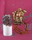 Buddha statue, candle holder, wooden beads Royalty Free Stock Photo