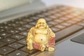 Buddha statue on computer keyboard symbolizing stress reduction and mindfulness