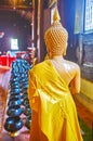 Buddha statue at donation bowls, Wat Phan Tao, Chiang Mai, Thailand