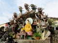 Buddha statue dressid in yellow with dragons