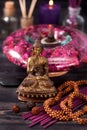 Buddha statue, essential oils, incense sticks. Spa and aromatherapy concept. Royalty Free Stock Photo