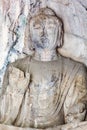 Buddha statue in grotto of Longmen Caves