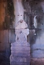 Buddha statue without a head. Ancient damaged sculpture in Angkor Wat