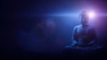 Buddha statue illuminated by subtle light in a dark setting Royalty Free Stock Photo