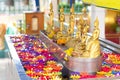 Buddha statue with Lotus multicolored candles floating in water.