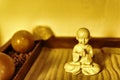 Buddha Statue in Lotus Position Sitting on the Sand. Buddha in Zen Garden With Smooth Lines in Sand. Royalty Free Stock Photo