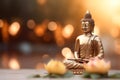 Buddha statue near flowers, blurred golden background