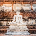 Buddha statue on old wall background in an ancient city in Thailand. Medieval Buddhist temple Wat Yai Chai Mongkhon in Ayutthaya Royalty Free Stock Photo