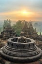 Buddha statue in open stupa in Borobudur when sunrise