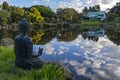 Buddha statue over looking a lake Royalty Free Stock Photo