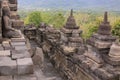 Buddha statue overlooking surroundings at Borobudur temple at sunrise in Java Indonesia Royalty Free Stock Photo